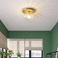 Plafonnier LED rond doré boule en verre AUREOLA